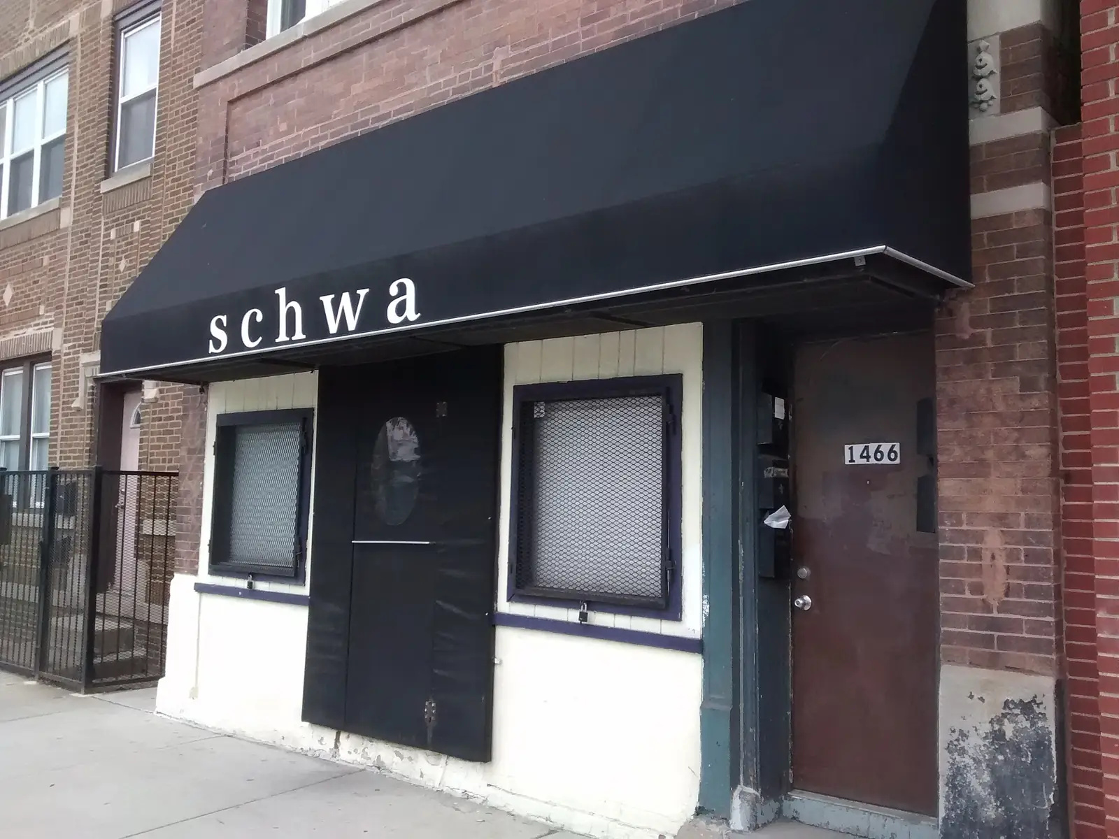 The black awning of a small restaurant on a Chicago street